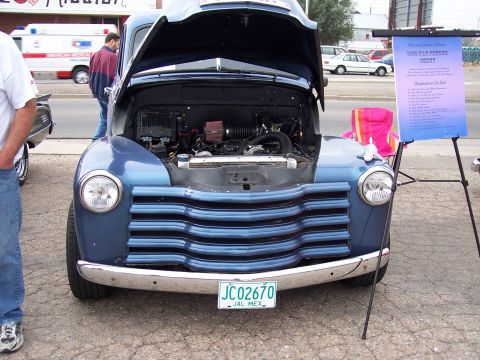 1972 Ford Ranchero - A blue pickup truck is displayed with its hood open, revealing the engine compartment.