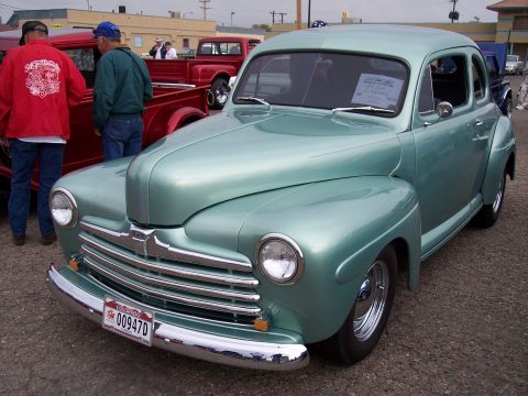 1972 Ford Ranchero - This 1946 Ford coupe has a distinctive grille and chrome accents, seen at a car show.