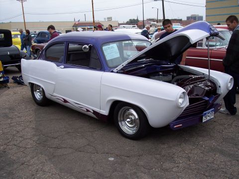 1972 Ford Ranchero - Two-tone custom sedan with hood open at a car show, other vehicles present.