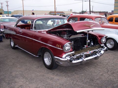 1972 Ford Ranchero - A maroon 1957 Chevrolet Bel Air is displayed with its hood open, alongside other vehicles.