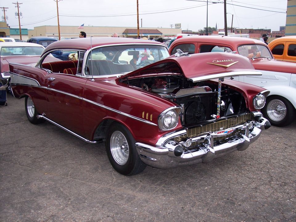 Maroon 1957 Chevrolet Bel Air with hood open, parked outdoors