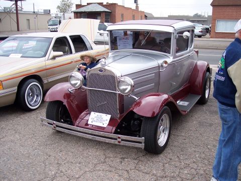 1972 Ford Ranchero - A classic silver and maroon Ford coupe is displayed at a car show, with another car visible to the left.