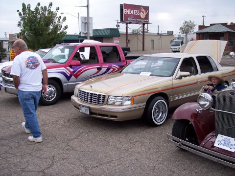 1972 Ford Ranchero - Several vehicles are parked together at an outdoor event, including a tan Cadillac sedan.