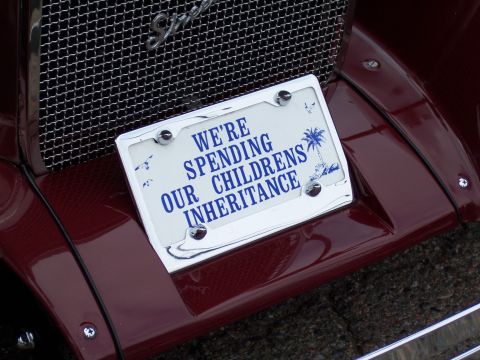 1972 Ford Ranchero - A license plate frame with a humorous message is attached to the fender of a maroon vehicle.