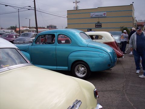 1972 Ford Ranchero - Several classic cars are parked in a lot, with a teal coupe prominently featured in the foreground.