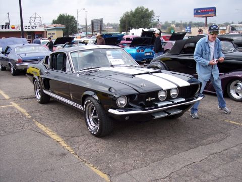 1972 Ford Ranchero - A black 1967 Ford Mustang Shelby GT500 is parked at an outdoor car show with other vehicles.