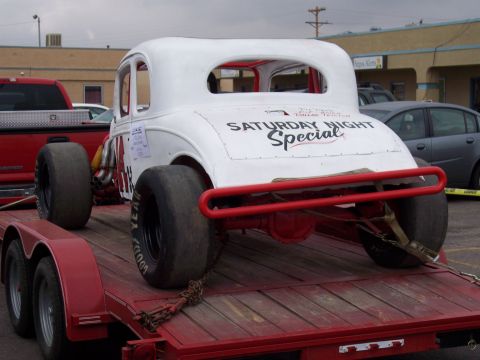 1972 Ford Ranchero - A white coupe race car, labeled 'Saturday Night Special', is loaded onto a red trailer.