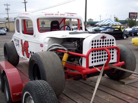 1972 Ford Ranchero - A heavily modified race car with large rear tires sits on a trailer, ready for transport.