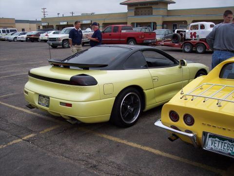 1972 Ford Ranchero - A yellow sports car with a black t-top and spoiler is parked next to a yellow Corvette.