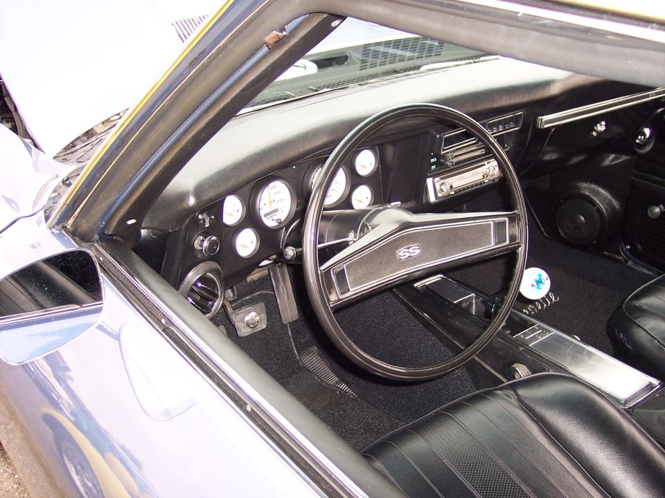 Interior view of a car showing the dashboard, SS steering wheel, and center console. Gauges and radio are visible