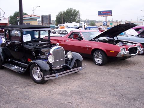 1972 Ford Ranchero - A red 1972 Ford Ranchero is displayed with its hood open at a car show, parked alongside a classic black coupe.