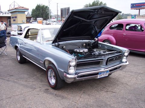 1972 Ford Ranchero - 1965 Pontiac GTO convertible on display with engine visible.