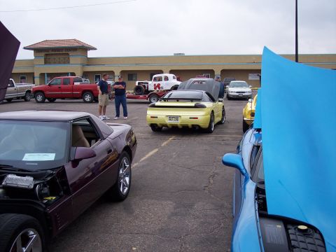 1972 Ford Ranchero - Several cars are parked in a lot with a building in the background.