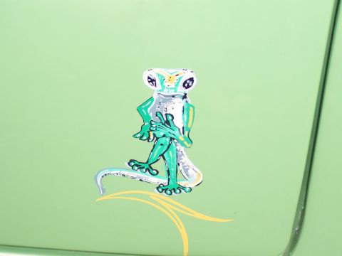 1972 Ford Ranchero - A cartoon gecko with a pinstripe design adorns the side of a light green vehicle.
