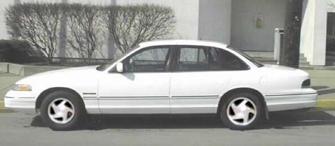 1987 Ford Crown Victoria LTD - This white sedan's body style suggests a 1992 model year, not a 1987 Ford Crown Victoria LTD.