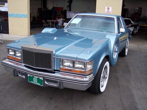1972 Ford Ranchero - This customized sedan has fender skirts and a continental kit, with another car visible in the background.