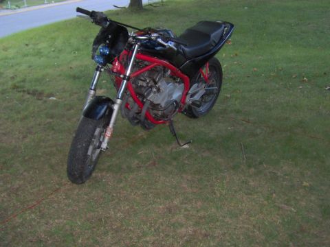 1993 Yamaha Seca II - A red-framed motorcycle with a black seat and fairing sits on a grassy lawn.