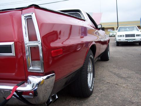 1972 Ford Ranchero - A red 1972 Ford Ranchero is parked on asphalt, with another white car in the background.