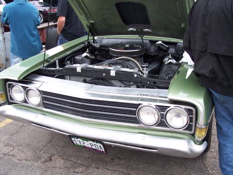 1972 Ford Ranchero - Front view of a green 1972 Ford Ranchero with its hood open, revealing the engine. The license plate reads 172-POA.
