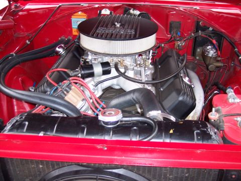 1972 Ford Ranchero - Close-up view of a V8 engine bay, a chrome air cleaner and red painted components.