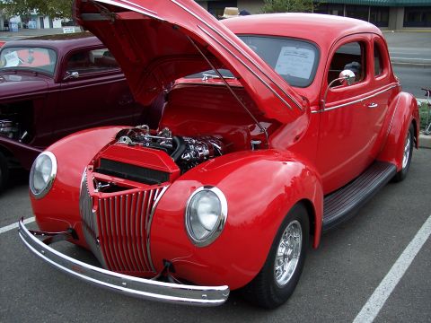 1972 Ford Ranchero - Red 1940 Ford coupe on display, hood raised to reveal the engine bay.