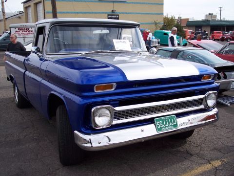 1972 Ford Ranchero - A classic pickup truck with a two-tone paint job is parked at an outdoor event.