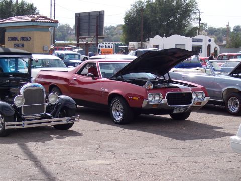 1972 Ford Ranchero - A red 1972 Ford Ranchero is displayed with its hood open at an outdoor car show.
