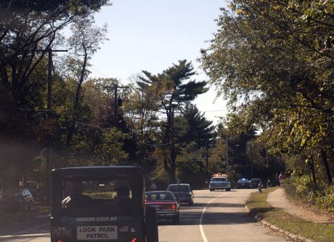 1973 Dodge 1500 - Vintage jeep with 'LOOK PARK PATROL' markings driving on a road with other vehicles.
