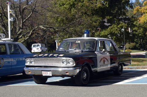 1973 Dodge 1500 - A classic police cruiser with 'POLICE' written on the hood and a badge on the door.