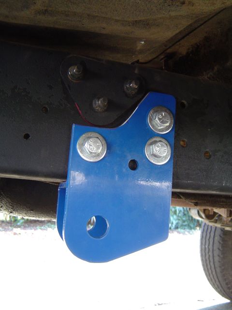1978 Ford Bronco - Close-up of a blue suspension component attached to the vehicle's frame.
