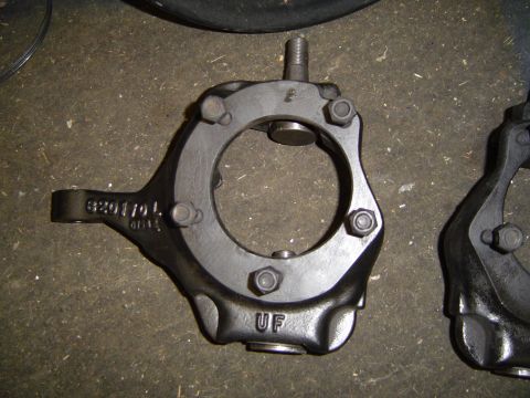 1978 Ford Bronco - Close-up of a cast iron steering knuckle part, showing stamped markings.