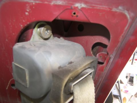 1978 Ford Bronco - Seatbelt retractor mechanism attached to the vehicle's body.