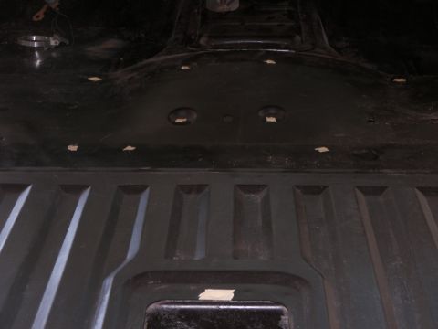 1978 Ford Bronco - The underside of a vehicle is shown, with several pieces of tape applied to various points.