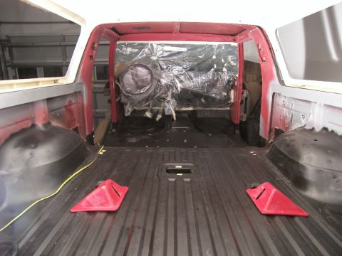 1978 Ford Bronco - The interior of a vehicle is shown during a renovation, with exposed metal and plastic-covered components visible.