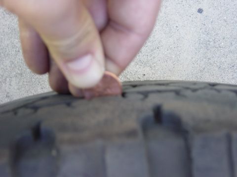 1983 Ferrari Enzo - A penny is used to check the tread depth on a tire. The registry claims this is a 1983 Ferrari Enzo, but the image shows only a tire.