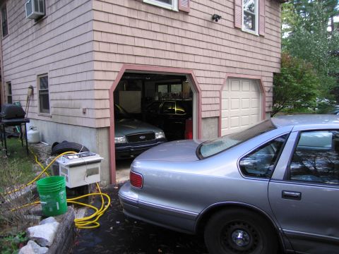 1991 Ford LTD Crown Victoria - A green Ford Crown Victoria is parked in a garage, partially obscured by a silver car in the foreground.