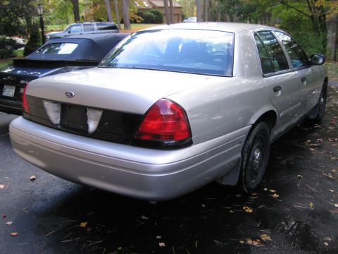 1991 Ford LTD Crown Victoria - Rear view of a silver 1991 Ford Crown Victoria LTD parked outdoors.