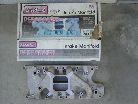 1983 Ferrari Enzo - An Edelbrock Performer intake manifold is shown next to its original packaging. The box details the product's features and specifications.
