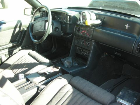 1998 Ford Crown Victoria - The interior of a 1993 Ford Mustang GT, its dashboard, steering wheel, and seats.