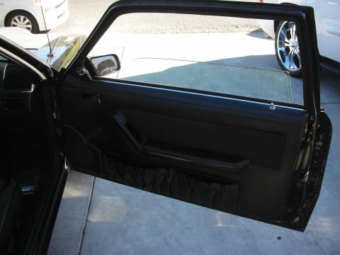 1998 Ford Crown Victoria - Interior view of a car door panel, with another vehicle visible in the background.