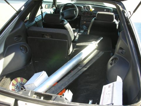 1998 Ford Crown Victoria - The interior and trunk of a car are visible, with parts loaded in the cargo area.