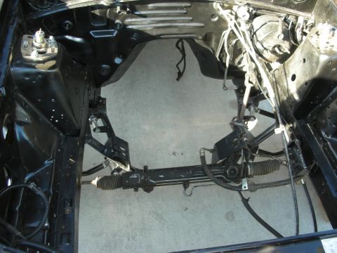 1998 Ford Crown Victoria - The engine bay frame of a vehicle is shown with its steering rack and suspension components visible.