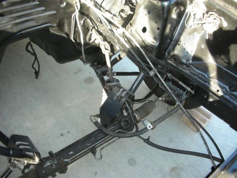 1998 Ford Crown Victoria - Close-up view of the steering rack and suspension system, likely from a disassembled vehicle.