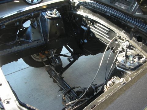 1998 Ford Crown Victoria - The engine bay of a car is shown, with the steering rack and suspension components clearly visible.