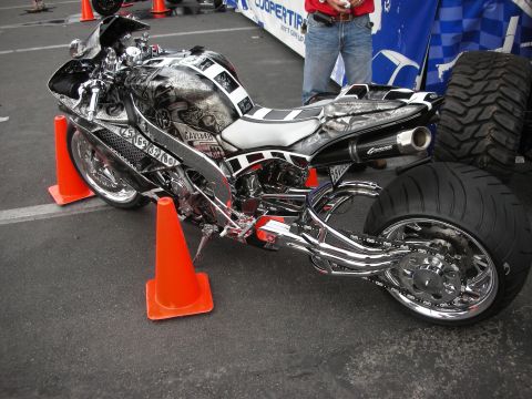 1998 Ford Crown Victoria - A highly customized motorcycle with intricate graphics and a prominent chrome exhaust system is displayed.