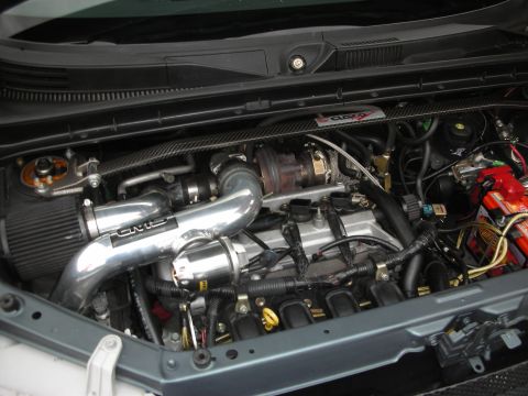 1998 Ford Crown Victoria - Customized engine bay a turbocharger and polished intake piping, likely for performance enhancement.