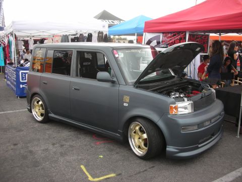 1998 Ford Crown Victoria - Modified Scion xB at an outdoor event, hood up to display the engine.