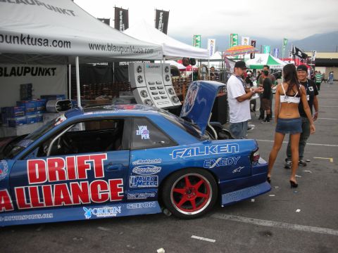 1998 Ford Crown Victoria - A blue drift car is parked at an outdoor event with tents and people around.