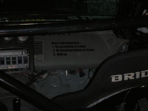 1998 Ford Crown Victoria - This race car interior features a humorous sign for passengers, along with racing seats and safety equipment.