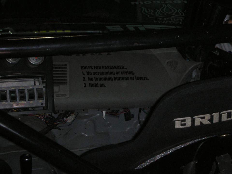 Roll-cage interior with 'Rules for Passenger' decal and gauges